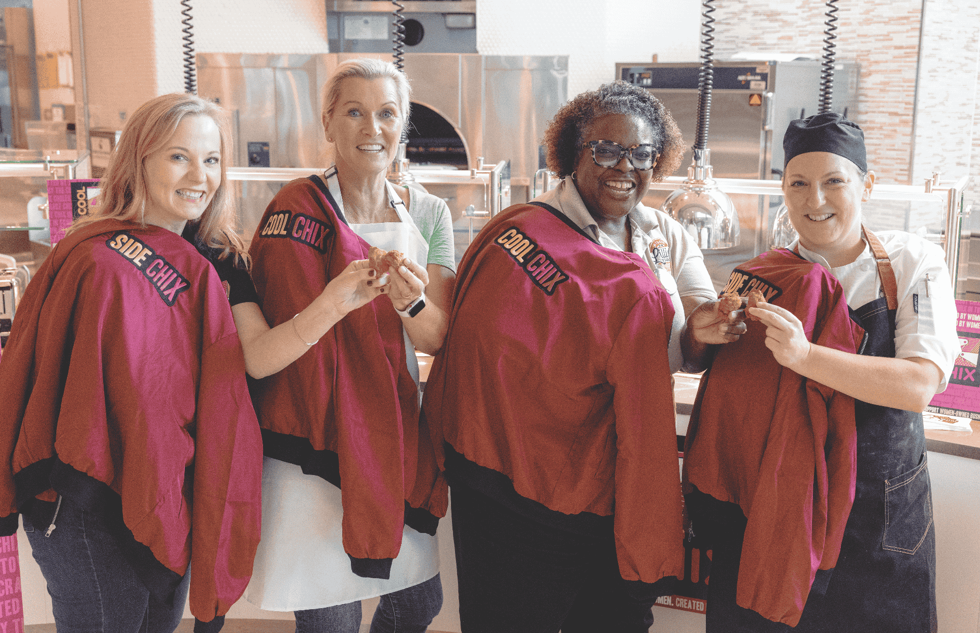 Compass Group staff wearing jackets taking pictures
