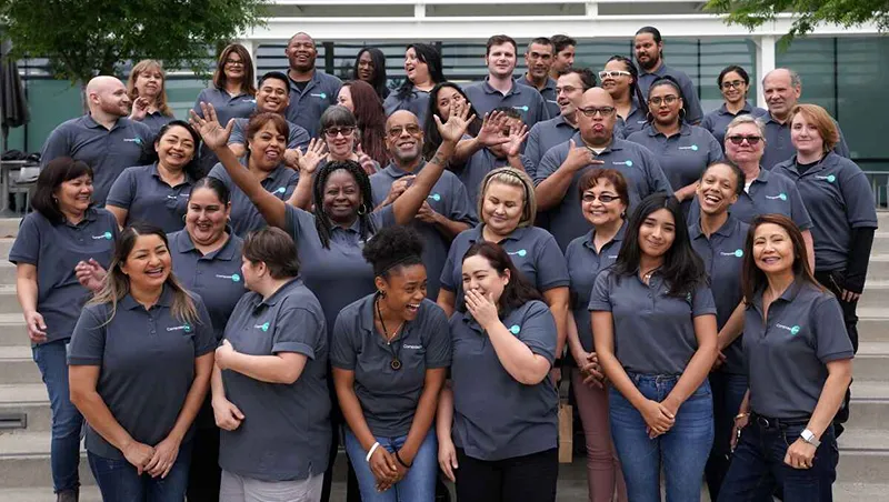 A group of people take a photo together
